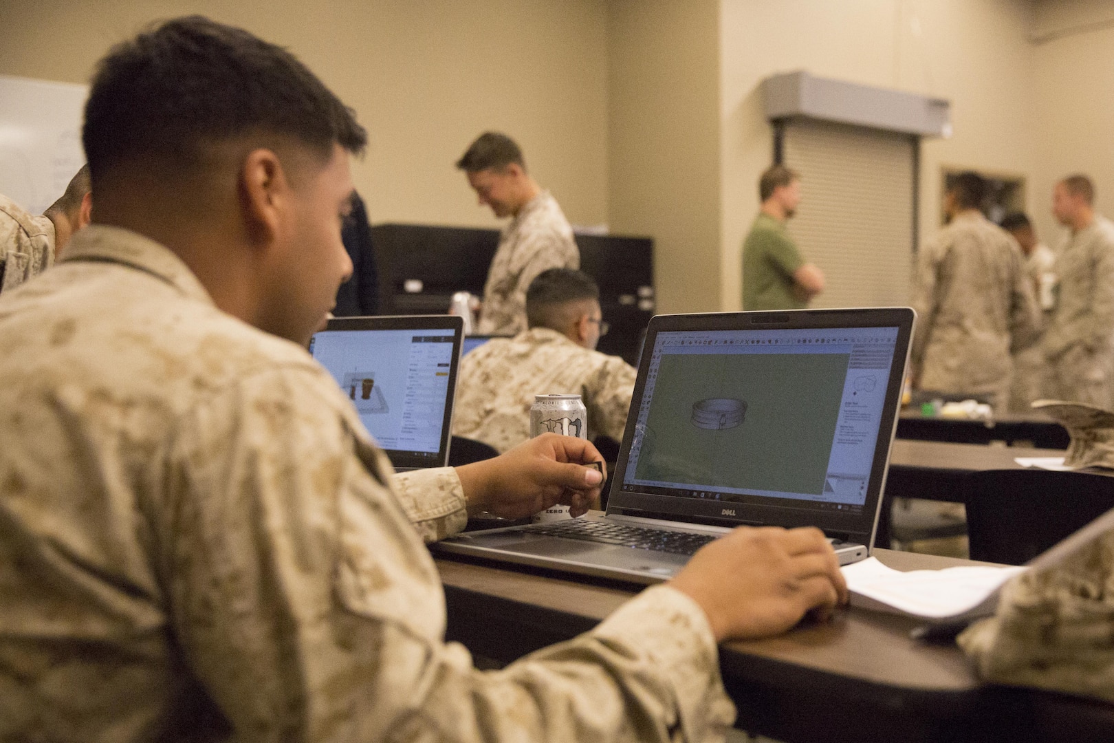 A Marine with 1st Battalion, 7th Marine Regiment, constructs an object using 3D printing technology during a 3D printing class aboard Marine Corps Air Ground Combat Center, Twentynine Palms, Calif., Nov. 16, 2016. Over the three-day course, Marines were challenged to manufacture innovative solutions for the problems presented to them using 3D printing innovation. (Official Marine Corps photo by Cpl. Medina Ayala-Lo/Released)