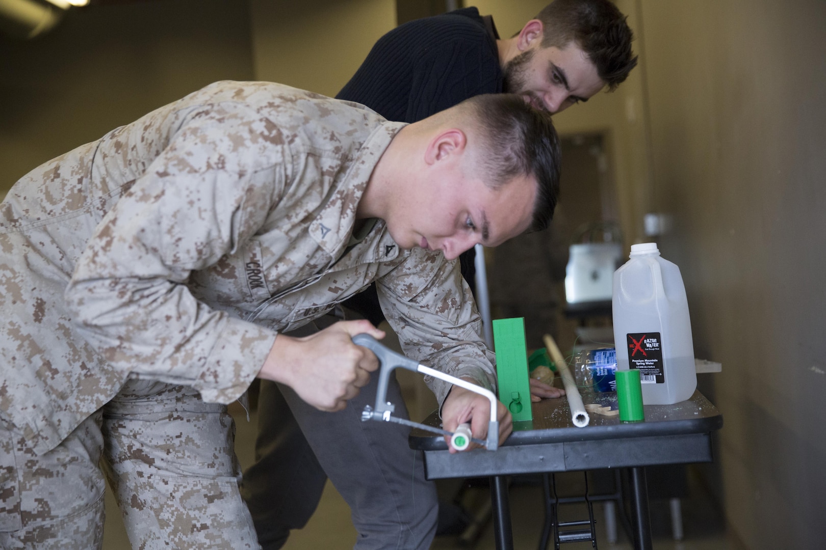 Lance Cpl. Tyler Crook, machinist, Combat Logistics Company 13, saws PVC piping during a 3D printing class aboard Marine Corps Air Ground Combat Center, Twentynine Palms, Calif., Nov. 16, 2016. Over the three-day course, Marines were challenged to manufacture innovative solutions for the problems presented to them using 3D printing innovation. (Official Marine Corps photo by Cpl. Medina Ayala-Lo/Released)