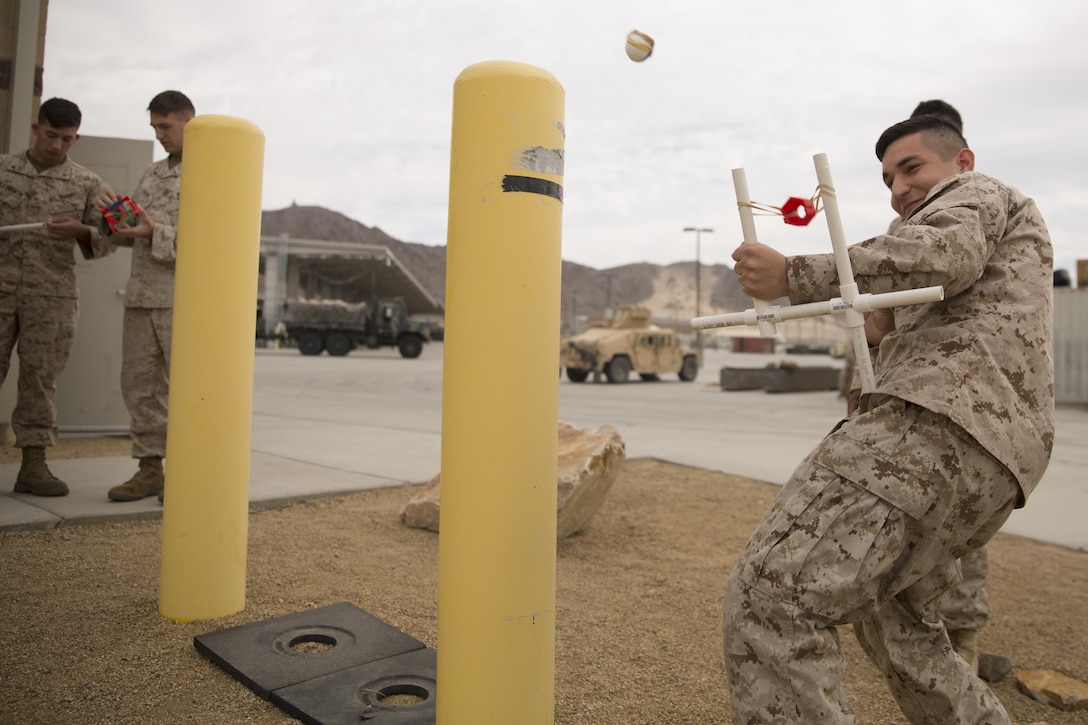 Lance Cpl. Jose Marroquin, electrical optical ordnance repair, 1st Battalion, 7th Marine Regiment, projects his ping pong using a make-shift sling shot during a 3D printing class aboard Marine Corps Air Ground Combat Center, Twentynine Palms, Calif., Nov. 16, 2016. Over the three-day course, Marines were challenged to manufacture innovative solutions for the problems presented to them using 3D printing innovation. (Official Marine Corps photo by Cpl. Medina Ayala-Lo/Released)