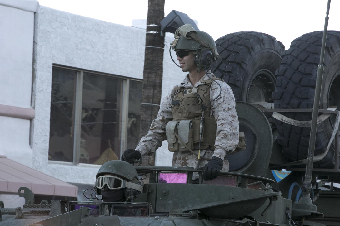 Sgt. Justin Puente, Light Armored Vehicle technician, 3rd Light Armored Reconnaissance Battalion, smiles at people from his LAV during the 20th annual Veteran's Day Parade in Palm Springs, Calif., Nov. 11, 2016. (Official Marine Corps photo by Cpl. Julio McGraw/Released)