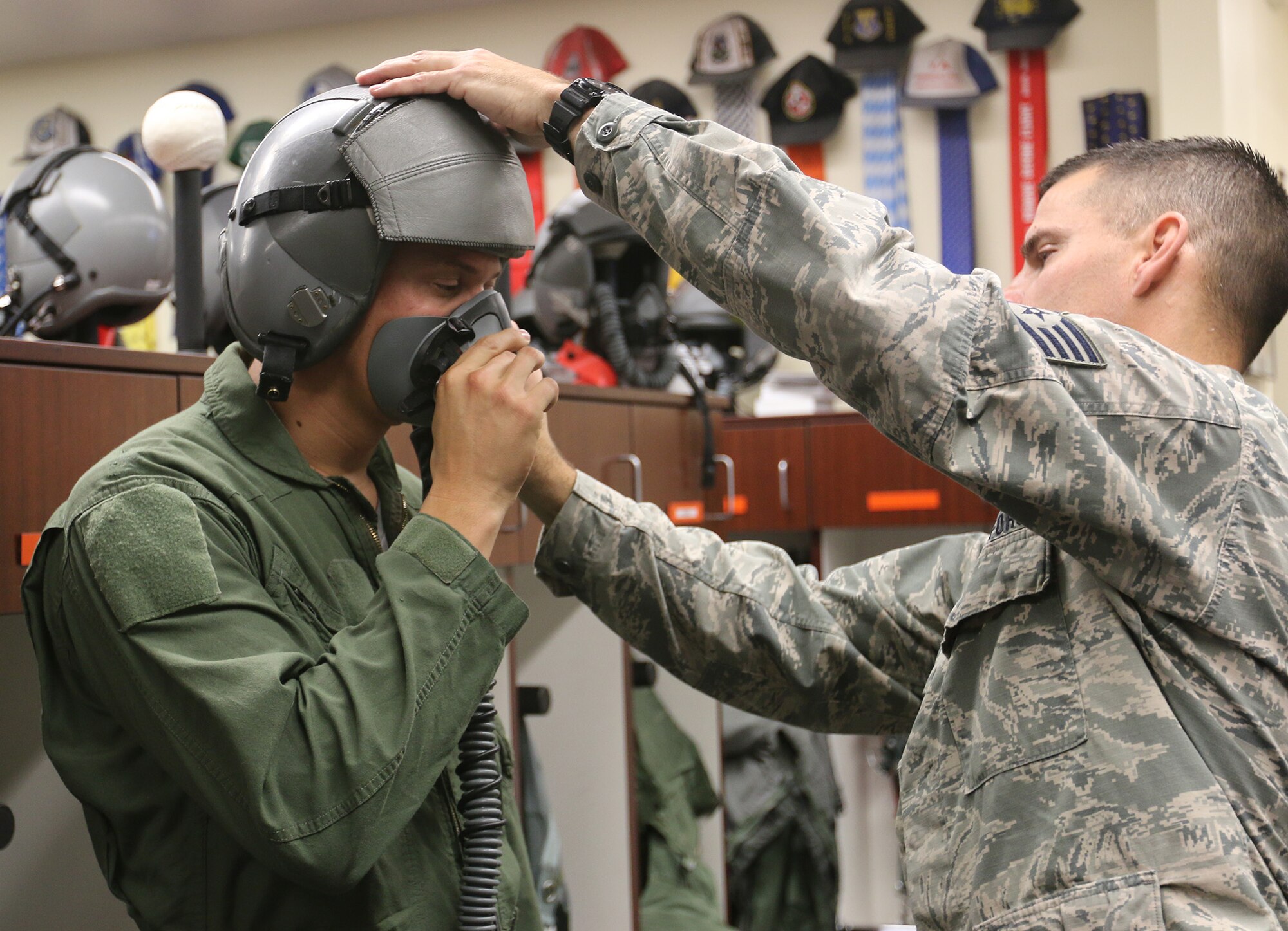 U.S. Marine Staff Sgt. (ret.) Charlie Linville is fitted with a helmet by U.S. Air Force SSgt Thomas Howard, 173rd Fighter Wing Aircrew Flight Equipment, in preperation for an F-15 familiarization flight with the Nov. 14, 2016 at Kingsley Field in Klamath Falls, Oregon. Linville, suffered an IED blast in Afghanistan in 2011 and subsequently lost his leg below the right knee. Despite his injuries he went on to become the first combat amputee to summit Mt. Everest, the world’s tallest mountain in May. He visited the Wing to speak to Airmen about his experiences both good and bad during his recovery. (U.S. Air National Guard photo by Tech. Sgt. Jefferson Thompson)