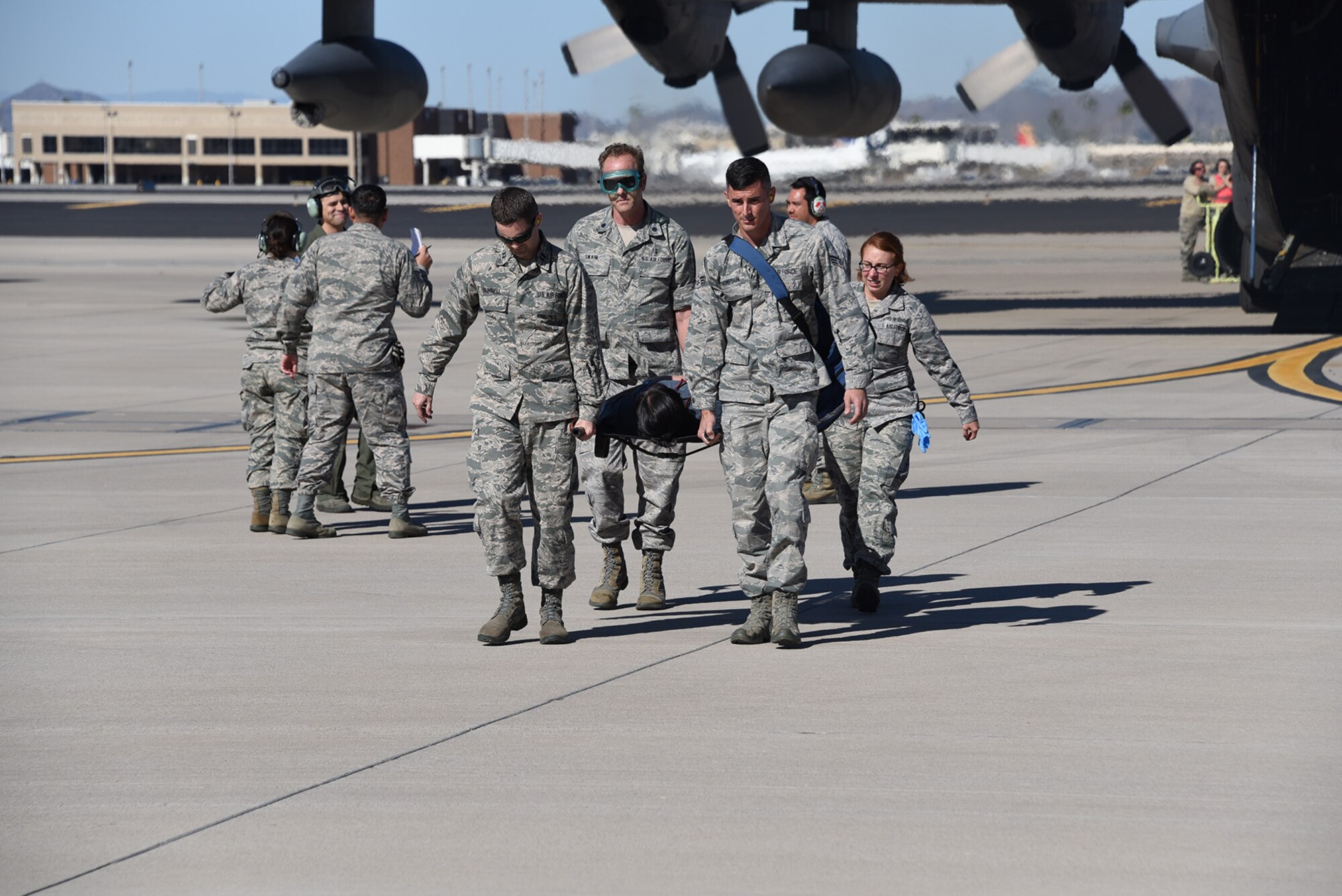 Medical personnel carry a patient off a C-130 Hercules aircraft for treatment during Vigilant Guard exercise at the 161st Air Refueling Wing in Phoenix, Arizona, Nov. 17, 2016. The Vigilant Guard exercise provides an opportunity for the Air and Army National Guard and to train in a joint operation environment. (U.S. Air National Guard photo by Master Sgt. Kelly Deitloff)