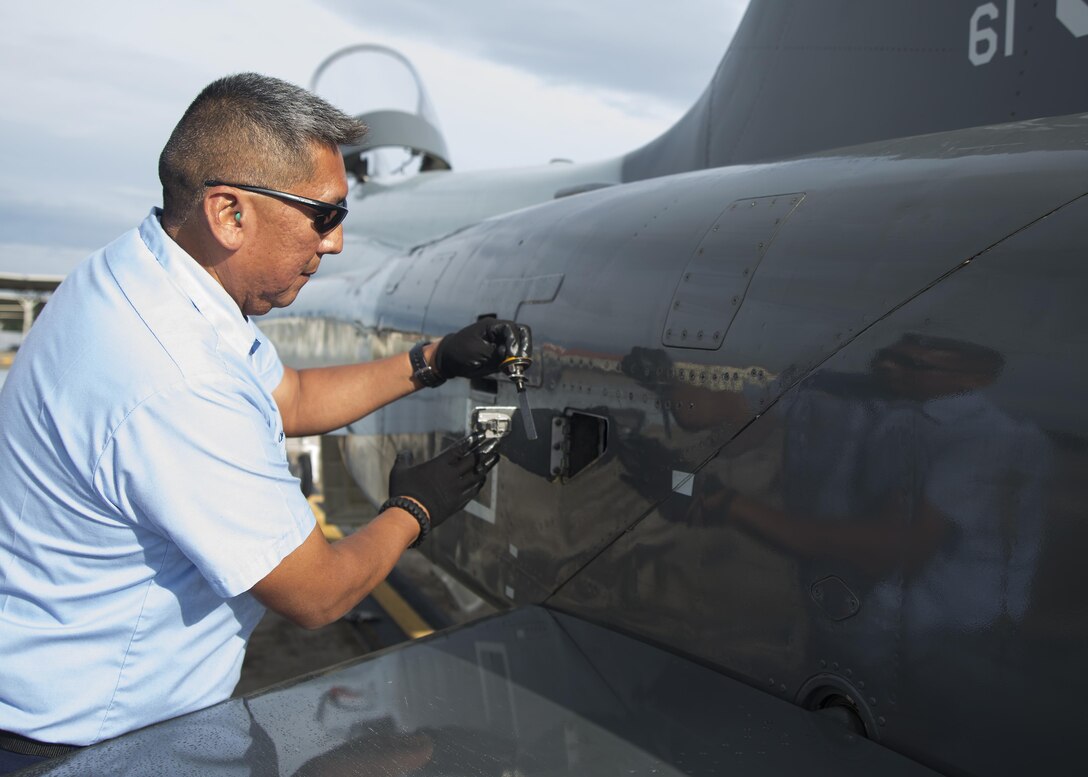 Chris Bahe, 12th Flying Training Wing T-38C Talon II crew chief, checks the oil of a T-38C during a pre-flight walk-around inspection at Joint Base San Antonio-Randolph Nov. 8, 2016. As a crew chief, Bahe supports the 435th Fighter Training Squadron, which conducts Introduction to Fighter Fundamentals student training in nearly 50 T-38C aircraft. (U.S. Air Force photo by Airman 1st Class Lauren Ely/Released)