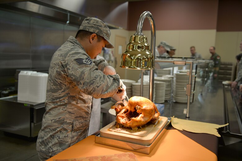 Staff Sgt. Danryll, 799th Air Base Squadron dining facility quality assurance member, carves a turkey November 16, 2016, at Creech Air Force Base, Nevada. With Thanksgiving approaching, Airmen are reminded to be safe while cooking and traveling. (U.S. Air Force photo by Airman 1st Class Kristan Campbell/Released)