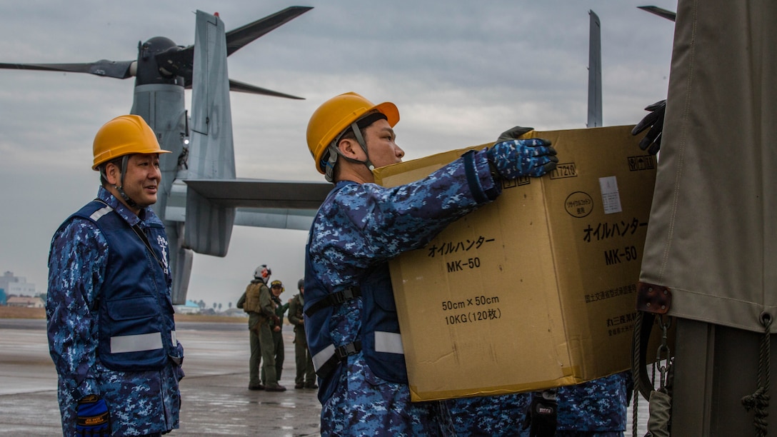 Japan Maritime Self-Defense Force members carry simulated humanitarian supplies from a MV-22B Osprey tiltrotor aircraft from Marine Medium Tiltrotor Squadron 262, 31st Marine Expeditionary Unit ,at Oruma Air Base, Nagasaki, Japan, Nov. 18, 2016. The aircraft flew from the island of Okinawa, conducted simulated humanitarian aid with the JMSDF at multiple locations and was refueled by JMSDF personnel before returning to Okinawa. The aircraft also conducted a passenger exercise carrying Sasebo Mayor Norio Tomonaga and the Assemblymen of Defense for Sasebo City. 