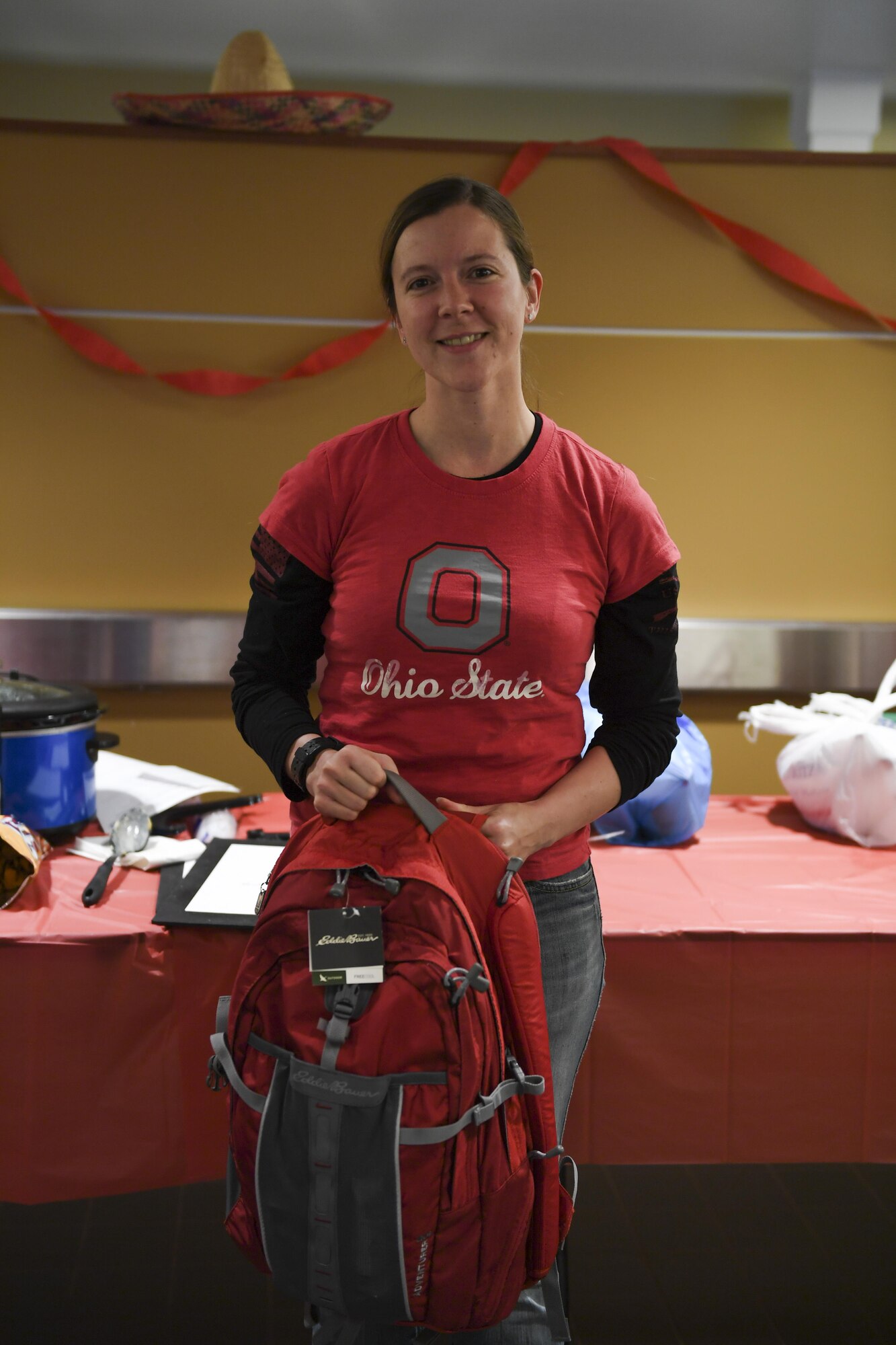 Tech Sgt. Dawn Hallock, medical service administrator with the 911th Aeromedical Evacuation Squadron, shows off backpack full of travel and survival supplies which she won at a chili and soup cook-of held at the Pittsburgh International Airport Air Reserve Station, Pa, November 18, 2016. Hallock made white chicken chili for the event, which was inspired by a recipe she had at a friend’s baby shower. (U.S. Air Force photo by Airman 1st Class Beth Kobily)