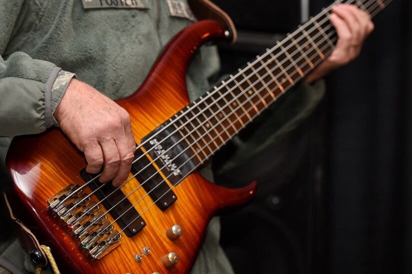 Master Sgt. David Foster, U.S. Air Force Band Max Impact bass player, strums the electric bass at the FedEx Field in Landover, Md., Nov. 20, 2016. He is one of six members that make up the rock band. The Redskins featured the band’s pregame performance during their military appreciation game. (U.S. Air Force photo by Airman 1st Class Valentina Lopez)