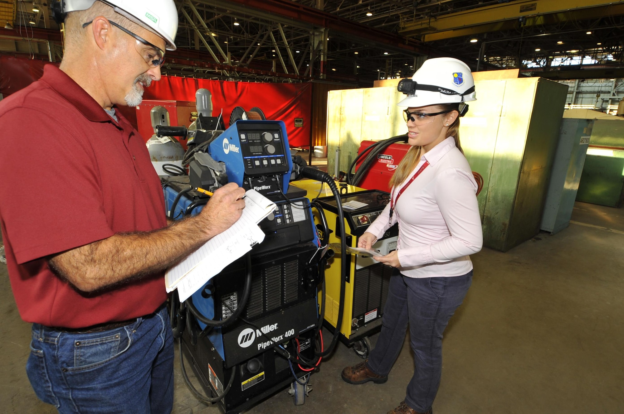 AEDC engineers Ashley Clark, right, and Tracy McDonald, check the performance of a welding machine at the Model and Machine Shop as part of the preventative maintenance program for the machines. Clark and McDonald worked to reduce the cost of the preventative maintenance program by developing a pre-operations checklist for each welding machine which moved a lot of the preventive maintenance program from a calendar driven program to a condition-based maintenance approach. This change is anticipated to yield a major cost savings for AEDC. (U.S. Air Force program/Rick Goodfriend) 