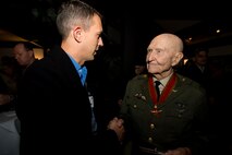 U.S. Air Force Lt. Col. Christopher Ott, 726th Air Mobility Squadron director of operations, right, shakes the hand of retired U.S. Air Force Col. Gail Halvorsen, a C-52 Skymaster pilot also known as the Candy Bomber, after the reopening ceremony of the Berlin Airlift Memorial outside Frankfurt International Airport, Germany, Nov. 22, 2016. Halvorsen and his fellow pilots dropped 23 tons of candy with makeshift parachutes from his C-54 as part of the Berlin Airlift, which delivered more than two million tons of food to the blockaded citizens of West Berlin between June 1948 and September 1949. (U.S. Air Force photo by Staff Sgt. Joe W. McFadden)