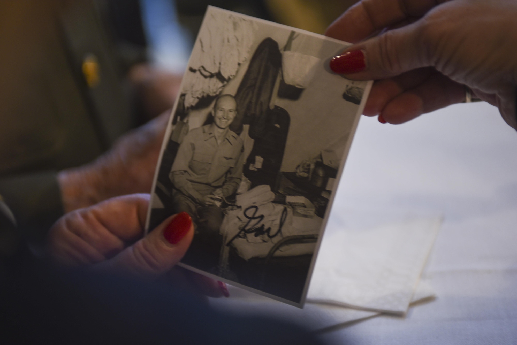 A German woman holds up a signed replica photo of then-U.S. Air Force 1st Lt. Gail Halvorsen, a C-52 Skymaster pilot also known as the Candy Bomber, after the reopening ceremony of the Berlin Airlift Memorial outside Frankfurt International Airport, Germany, Nov. 22, 2016. Halvorsen and his fellow pilots dropped 23 tons of candy with makeshift parachutes from his C-54 as part of the Berlin Airlift, which delivered more than two million tons of food to the blockaded citizens of West Berlin between June 1948 and September 1949. (U.S. Air Force photo by Staff Sgt. Joe W. McFadden)