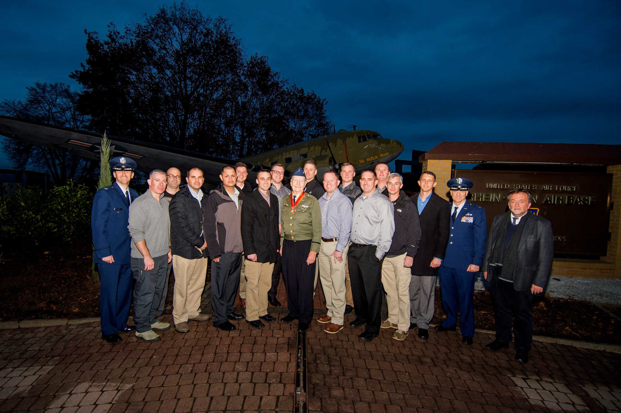 Retired U.S. Air Force Col. Gail Halvorsen, a C-52 Skymaster pilot also known as the Candy Bomber, center, poses with U.S. Air Forces in Europe Airmen from Spangdahlem Air Base, Germany, and Ramstein Air Base, Germany, after the reopening ceremony of the Berlin Airlift Memorial outside Frankfurt International Airport, Germany, Nov. 22, 2016. Most of the Airmen serve with the 726th Air Mobility Squadron, which traces its lineage to Halvorsen's efforts as part of the airlift, which delivered more than two million tons of food to the blockaded citizens of West Berlin between June 1948 and October 1949. (U.S. Air Force photo by Staff Sgt. Joe W. McFadden)
