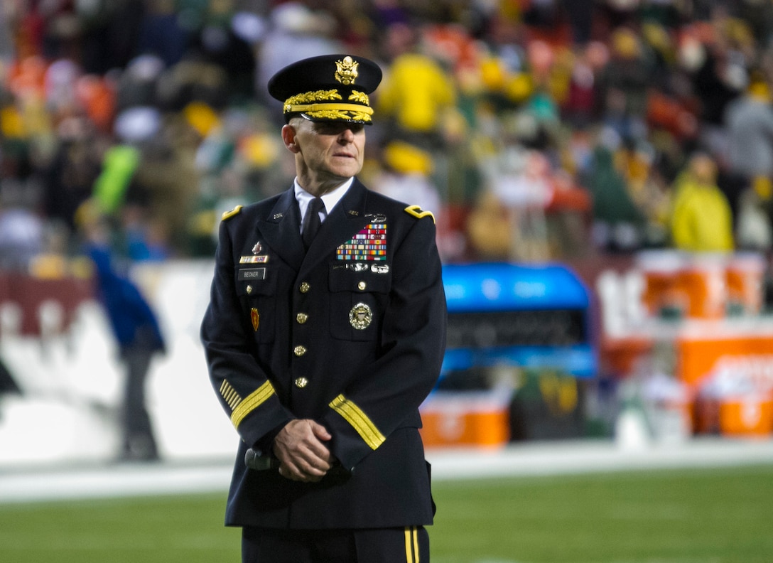 Maj. Gen. Bradley A. Becker, Commanding General of the Military District of Washington, prepares to give the oath of enlistment to new and current Soldiers during the NFL military appreciation game at Fedex Field in Landover, Maryland, Nov. 20. Prior to the enlistment ceremony, U.S. Army Reserve and Active Duty Military Police Soldiers showcased military vehicles and aircraft, as well as military working dogs to the public. (U.S. Army Reserve photo by Sgt. Jennifer Spiker)