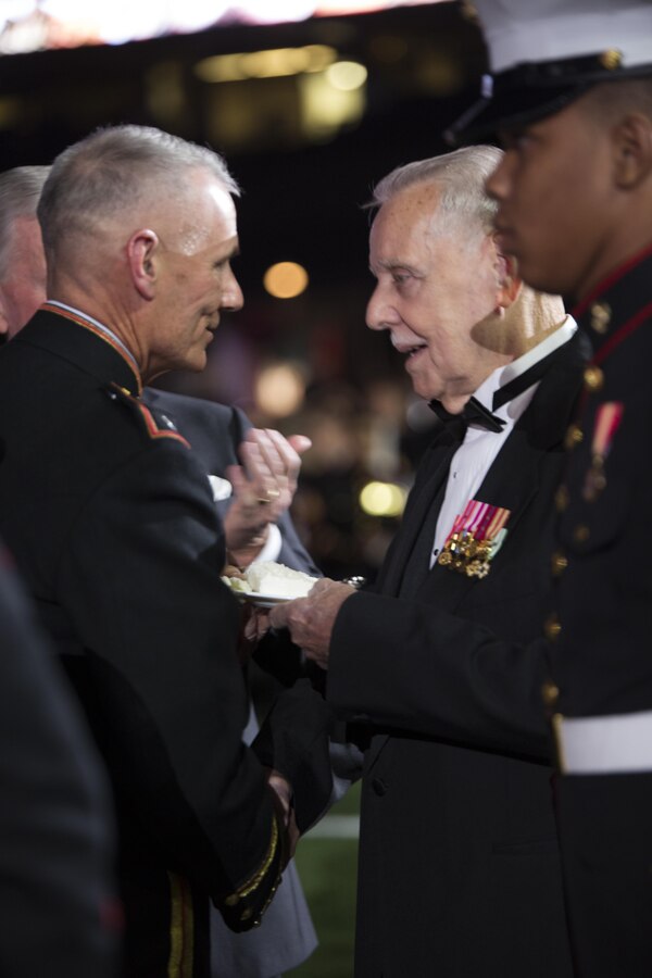 Lt. Gen. Rex C. McMillian (left), commander of Marine Forces Reserve and Marine Forces North, passes the second piece of cake to retired Sgt. Maj. Raymond A. Liss, the oldest Marine present, during the MARFORRES birthday ball at the Mercedes-Benz Superdome, Nov. 19, 2016. Liss enlisted in the Marine Corps in 1953 as a cannoneer, and retired in 1984 as the Sergeant Major of 4th Marine Division in New Orleans. Each year, a ball is hosted to celebrate the birthday of the Corps and to remember Marines who have given the ultimate sacrifice. Since its establishment in 1775, the Marine Corps has fought and won our nation’s battles. (U.S. Marine Corps photo by Cpl. Melissa Martens/ Released) 