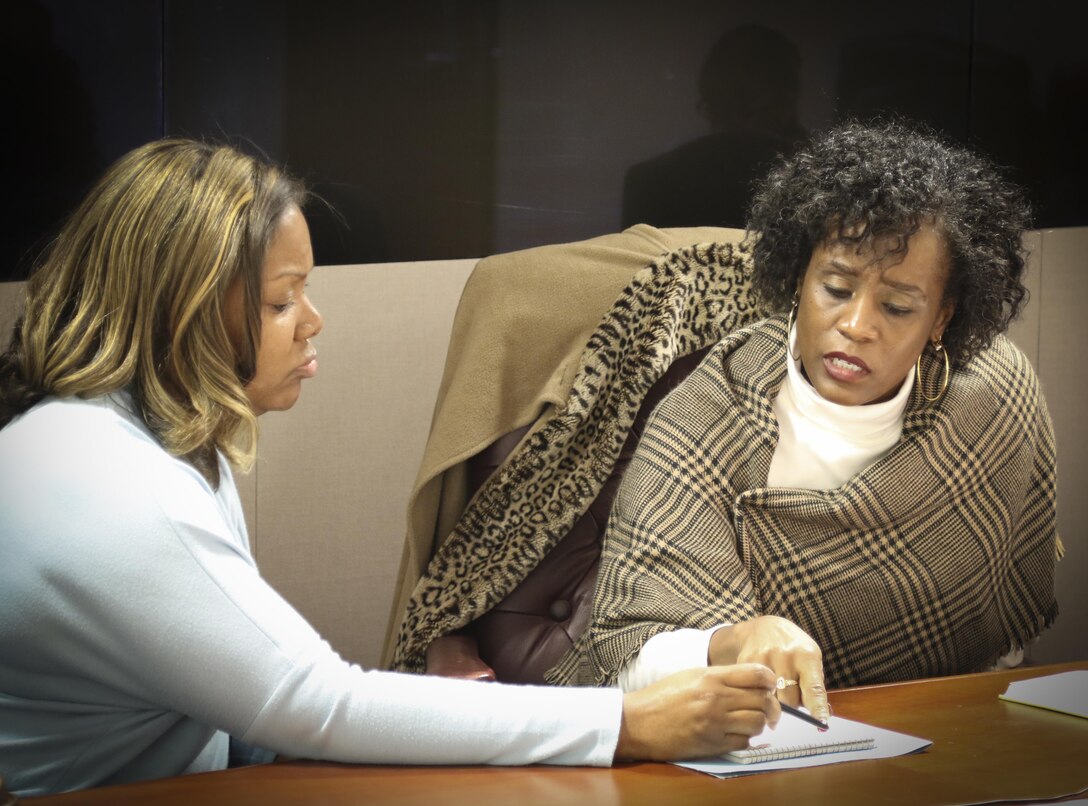 Mrs. Natasha Whitfield (left), PhD., a clinical psychologist with the Substance Abuse Treatment Program of the Atlanta Veterans Affairs Medical Center discusses substance abuse treatment concerns with Ms. Wyuca D. Bradham, an alcohol and drug control officer assigned to the 3rd Medical Command (Deployment Support), during a Substance Abuse Action Meeting at the 335th Signal Command (Theater) headquarters Nov. 21.  The meeting, which was attended by Soldiers and civilians, provided attendees with an opportunity for two-way communication and consultation with subject matter experts.