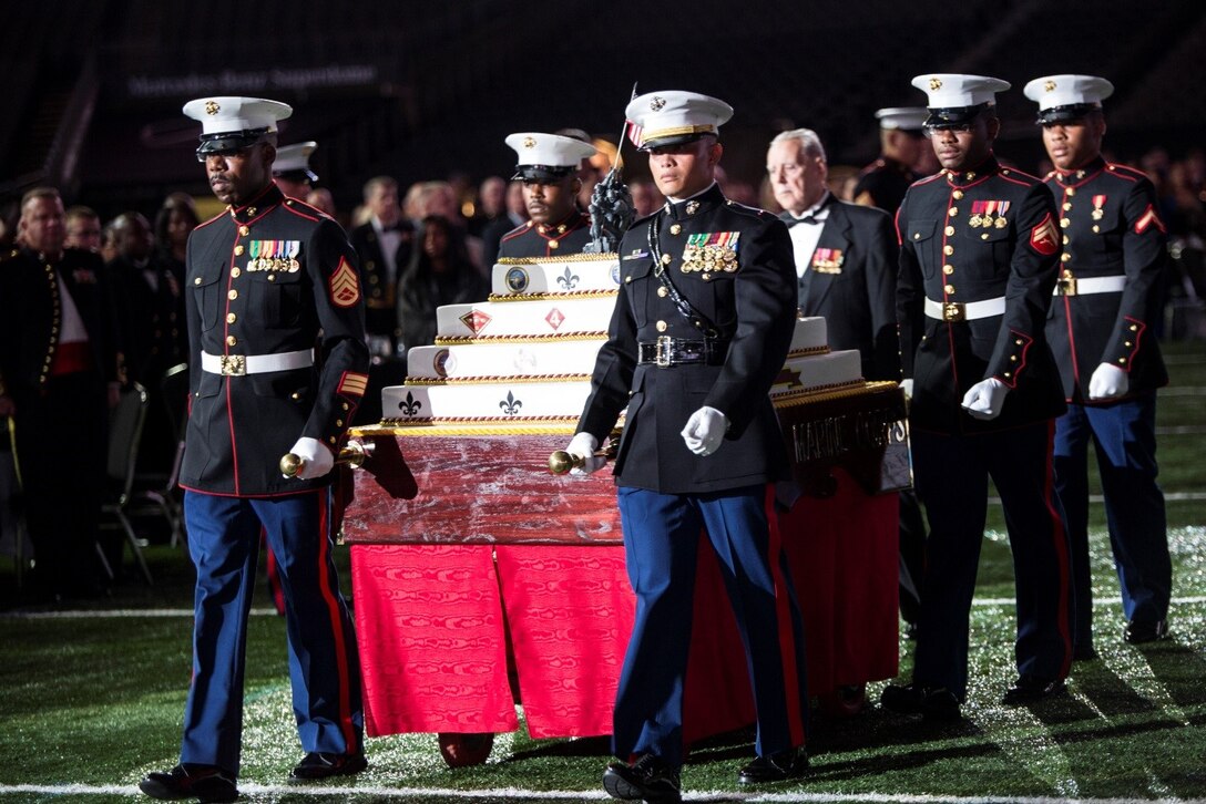 Staff Sgt. Anthony J. Roberts (left), current operations staff non-commissioned officer, Marine Forces Reserve G-1, and Chief Warrant Officer 3 Jason M. Pierce, logistics systems coordinating office officer-in-charge, MARFORRES G-4, lead the cake escort during the MARFORRES birthday ball at the Mercedes-Benz Superdome, Nov. 19, 2016. Each year, a ball is hosted to celebrate the birthday of the Corps and to remember Marines who have given the ultimate sacrifice. Since its establishment in 1775, the Marine Corps has fought and won our nation’s battles. (U.S. Marine Corps photo by Cpl. Melissa Martens/ Released)