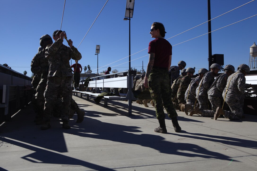Army Master Cpl. Jessome Kathrien, of the Queen's Own Rifles of Canada, instructs U.S. Army soldiers in aircraft drill refresher exercises, at March Air Reserve Base, Riverside Calif., November 18, 2016. Exercise TOPHAM is a multinational Airborne exercise hosted by the 426th Civil Affairs Battalion at March Air Reserve Base and Camp Pendleton, Calif., with field exercises on Civil Military Operations Center and Civil Information Management key collective tasks. (U.S. Army photo by Sgt. Phillip McTaggart/Released)Exercise TOPHAM is a multinational Airborne exercise hosted by the 426th Civil Affairs Battalion at March Air Reserve Base and Camp Pendleton, Calif., with field exercises on Civil Military Operations Center and Civil Information Management key collective tasks. (U.S. Army photo by Sgt. Phillip McTaggart/Released)