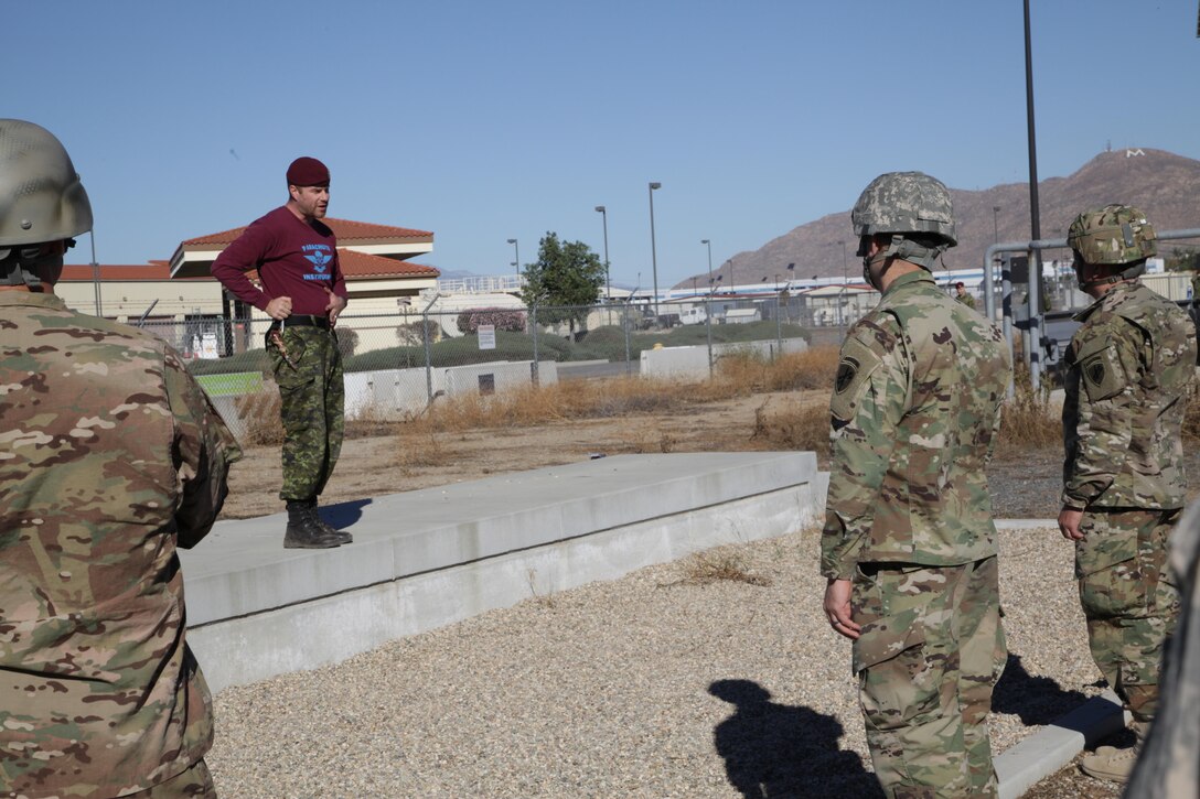 Warrant Officer Bryan Burns a member of the Queen's Own Rifles of Canada, conducts flight training refresher with U.S. Army Airborne paratroopers of the 358th Civil Affairs Brigade at March Air Reserve Base, Nov. 18, 2016. Exercise TOPHAM is a multinational Airborne exercise hosted by the 426th Civil Affairs Battalion at March Air Reserve Base and Camp Pendleton, Calif., with field exercises on Civil Military Operations Center and Civil Information Management key collective tasks. (U.S. Army photo by Sgt. 1st Class Horace Murray/Released)