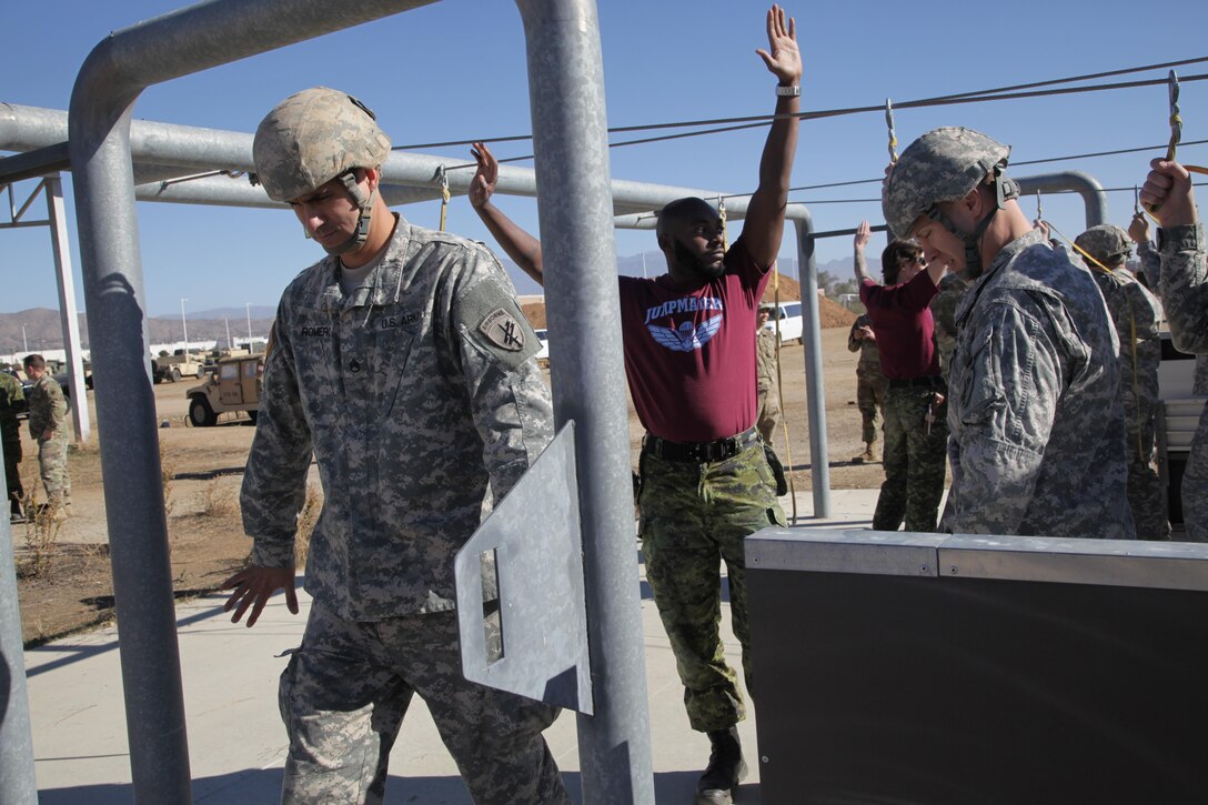 U.S. Army Staff Sgt. James Romero a member of the 416th Civil Affairs Battalion (Airborne), takes part in aircraft drill refresher given by Canadian Jumpmasters by exiting the mock door at March Air Reserve Base, Nov. 18, 2016. Exercise TOPHAM is a multinational Airborne exercise hosted by the 426th Civil Affairs Battalion at March Air Reserve Base and Camp Pendleton, Calif., with field exercises on Civil Military Operations Center and Civil Information Management key collective tasks. (U.S. Army photo by Sgt. 1st Class Horace Murray/Released)