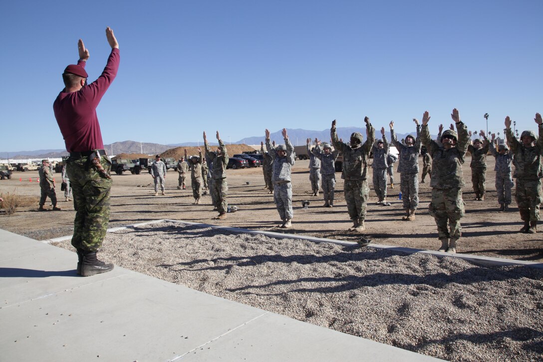 Warrant Officer Bryan Burns a member of the Queen's Own Rifles of Canada,, conducts flight training refresher with U.S. Army Airborne paratroopers at March Air Reserve Base, Nov. 18, 2016. Exercise TOPHAM is a multinational Airborne exercise hosted by the 426th Civil Affairs Battalion at March Air Reserve Base and Camp Pendleton, Calif., with field exercises on Civil Military Operations Center and Civil Information Management key collective tasks. (U.S. Army photo by Sgt. 1st Class Horace Murray/Released)