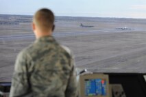 Airman 1st Class Christopher Quesenberry, 5th Operations Support Squadron air traffic controller, monitors B-52H Stratofortresses’ as they prepare for take-off at Minot Air Force Base, N.D., Nov. 15, 2016. Controllers are in constant communication with both pilots and ground crews to ensure aircraft safety during taxiing, take-off and landing. (U.S. Air Force photo/Senior Airman Kristoffer Kaubisch)
