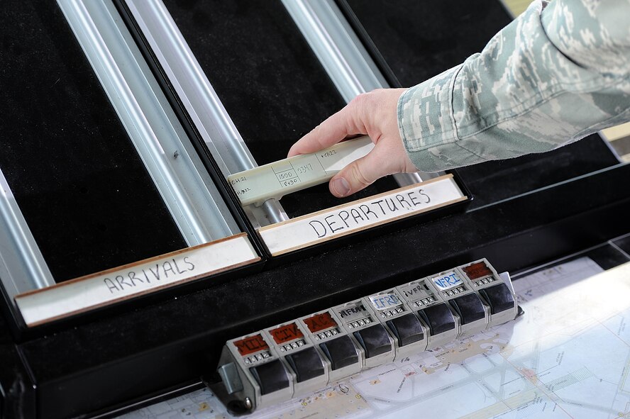 Senior Airman Erik Johnson, 5th Operations Support Squadron air traffic controller, annotates flight line discrepancy coordinates at the control tower on Minot Air Force Base, N.D., Nov. 15, 2016. Air traffic controllers operate air traffic systems to expedite and maintain a safe and orderly air traffic flow of all aircraft on base. (U.S. Air Force photo/Senior Airman Kristoffer Kaubisch)