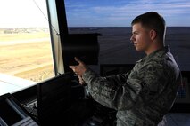 Airman 1st Class Christopher Quesenberry, 5th Operations Support Squadron air traffic controller, uses a light gun from the control tower at Minot Air Force Base, N.D., Nov. 15, 2016. Light guns are used to communicate with or direct aircraft in the case of radio failure. (U.S. Air Force photo/Senior Airman Kristoffer Kaubisch)