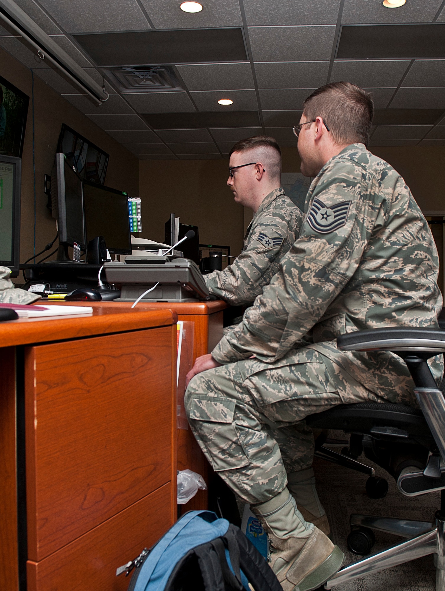 (From left) Senior Airman Benjamin Haun, 5th Maintenance Group maintenance operations flight weapons systems controller, and Tech. Sgt. Charles Clay, 5th MXG maintenance operations flight senior weapons systems controller, update flight information at Minot Air Force Base, N.D., Nov. 15, 2016. Haun and Clay are responsible for planning, monitoring and scheduling all flight line maintenance. (U.S. Air Force photo/Airman 1st Class Jonathan McElderry)