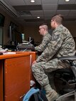 (From left) Senior Airman Benjamin Haun, 5th Maintenance Group maintenance operations flight weapons systems controller, and Tech. Sgt. Charles Clay, 5th MXG maintenance operations flight senior weapons systems controller, update flight information at Minot Air Force Base, N.D., Nov. 15, 2016. Haun and Clay are responsible for planning, monitoring and scheduling all flight line maintenance. (U.S. Air Force photo/Airman 1st Class Jonathan McElderry)