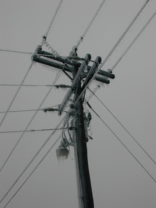 Glaze ice, formed by slow freezing rate, coating a utility pole.