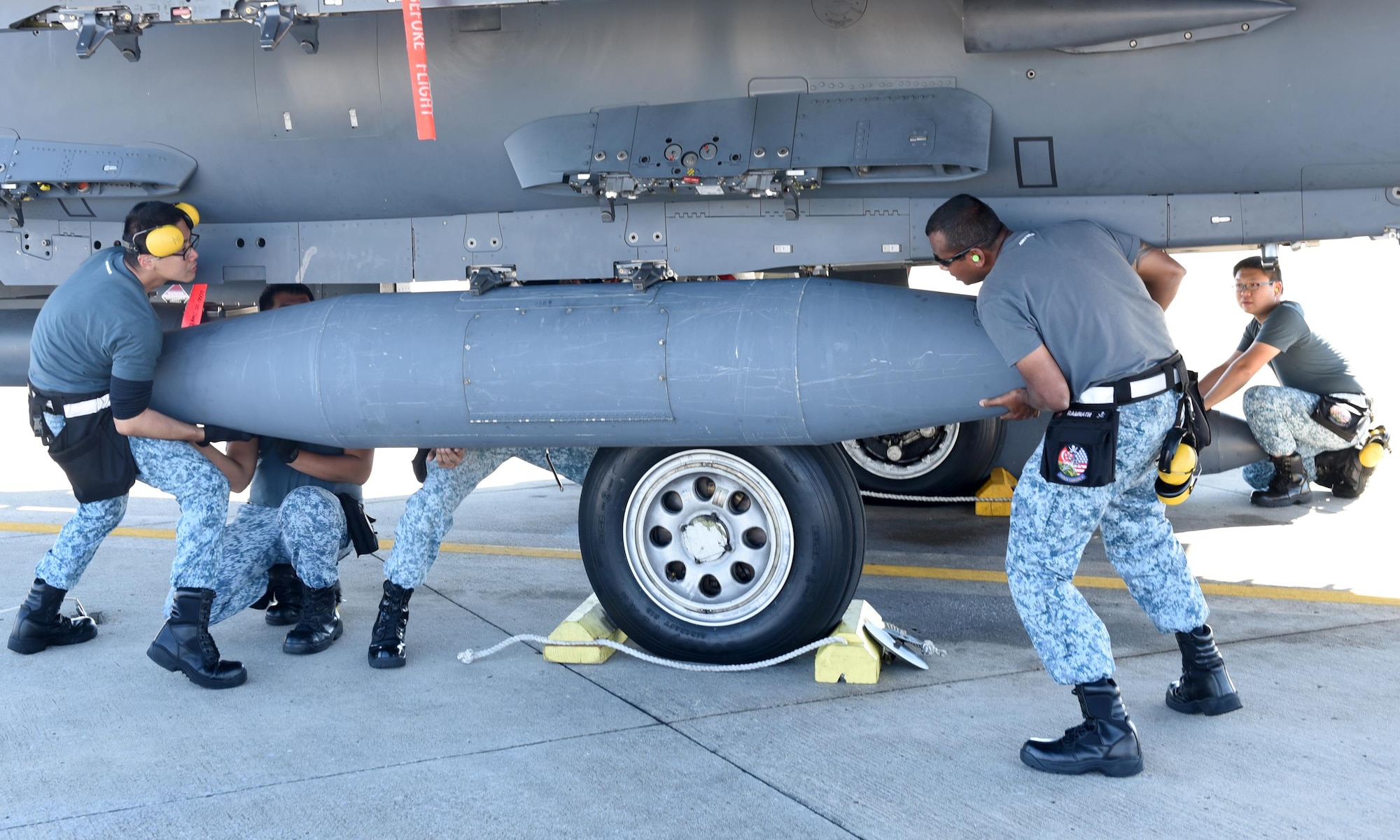 Singapore air force maintainers from the 428th Fighter Squadron, Mountain Home Air Force Base, Idaho, load fuel tanks onto an F-15 Eagle at Tyndall Air Force Base, Fla., Nov. 17, 2016. The Singapore air force took part in the Weapons Systems Evaluation program, an exercise intended to evaluate weapon systems in their entirety, including aircraft, weapon delivery system, weapon, aircrew, technical data and maintenance. (U.S. Air Force photo by Airman 1st Class Cody R. Miller/Released)