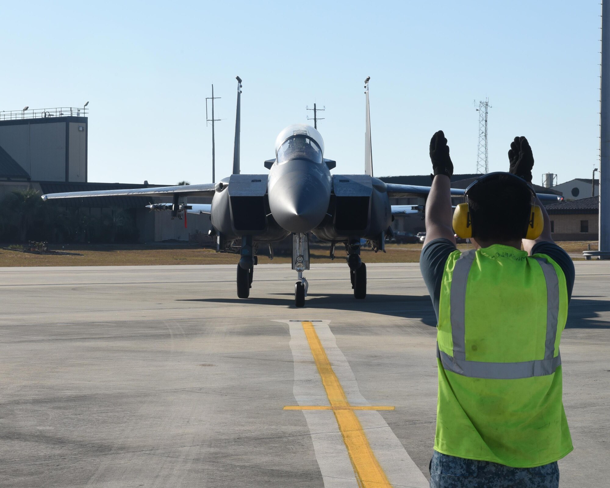 A Singapore air force crew chief marshals an F-15 Eagle from the 428th Fighter Squadron, Mountain Home Air Force Base, Idaho, into a parked position after a training flight at Tyndall Air Force Base, Fla., Nov. 17, 2016. Singaporean pilots from squadrons at Mountain Home AFB and Luke AFB, Ariz., came to Tyndall to participate in live-fire exercises with their U.S. counterparts. (U.S. Air Force photo by Airman 1st Class Cody R. Miller/Released) 