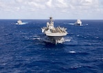 In this file photo, the Makin Island Amphibious Ready Group (ARG) underway in the western Pacific Ocean. The Makin Island ARG is comprised of the amphibious assault ship USS Makin Island (LHD 8), center, the amphibious dock landing ship USS Comstock (LSD 45), left, and the amphibious transport dock ship USS Somerset (LPD 25), Oct. 28, 2016. The ships are deployed with the embarked 11th Marine Expeditionary Unit in support of the Navy’s maritime strategy in the U.S. 3rd Fleet area of responsibility.