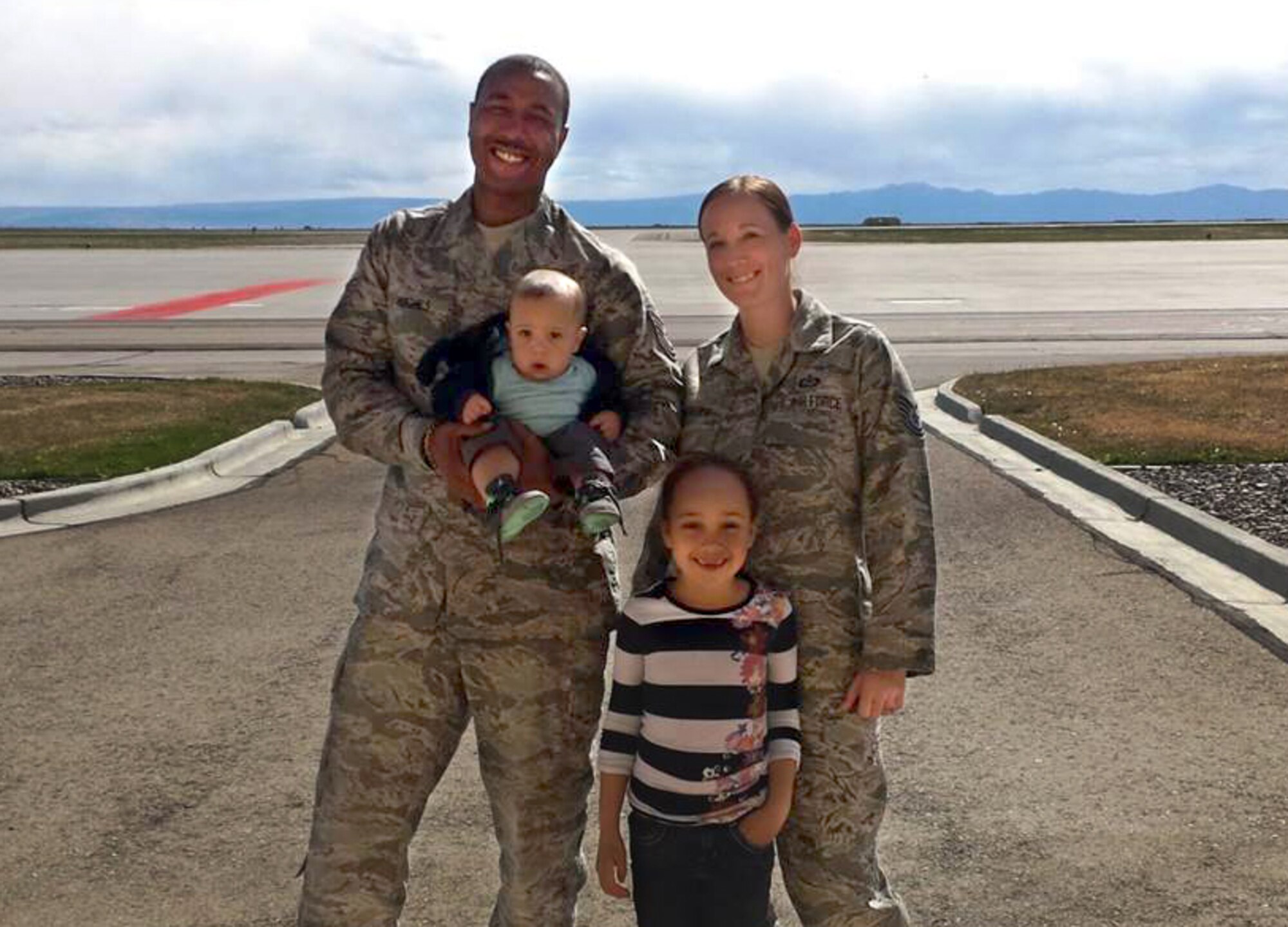 Master Sgt. Cortny Hughes, Master Sgt. Donald Hughes and their family.
