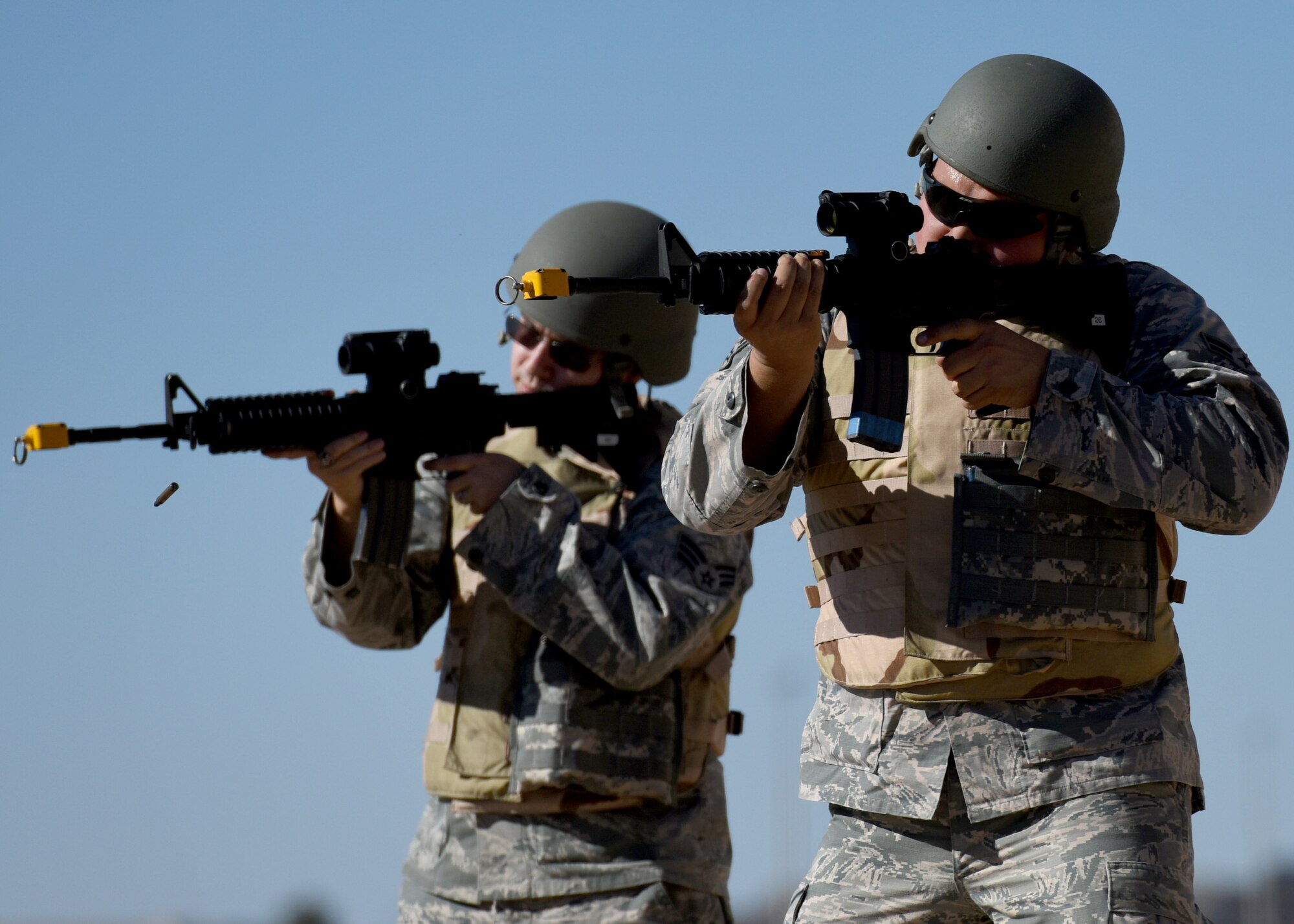 Airmen fire blanks as part of a tactical reload drill during a pre-deployment course, Nov. 15, 2016, at Altus Air Force Base, Oklahoma. Before each Airman deploys out of Altus, they must first complete a pre-deployment class which teaches them to be proficient and confident in handling weapons and combat applicable skills. (U.S. Air Force photo by Senior Airman Nathan Clark/Released)