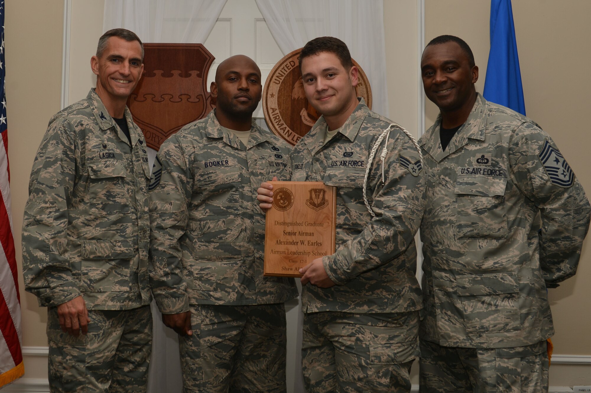 U.S. Air Force Senior Airman Alexander Earls, 3rd Intelligence Squadron, receives a distinguished graduate award for the Senior Master Sgt. David B. Reid Airman Leadership School Class 17-1 at Shaw Air Force Base, S.C., Nov. 18, 2016. The distinguished graduate awards are given to the top 10 percent of the class for total point accumulation. (U.S. Air Force photo by Airman 1st Class Christopher Maldonado)