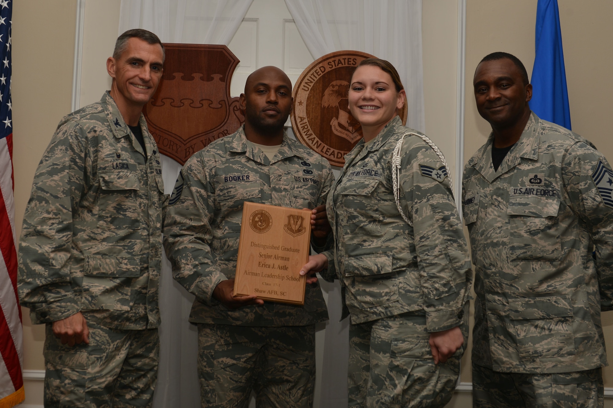 U.S. Air Force Senior Airman Erica Astle, 3rd Intelligence Squadron, receives a distinguished graduate award for the Senior Master Sgt. David B. Reid Airman Leadership School Class 17-1 at Shaw Air Force Base, S.C., Nov. 18, 2016. The distinguished graduate awards are given to the top 10 percent of the class for total point accumulation. (U.S. Air Force photo by Airman 1st Class Christopher Maldonado)