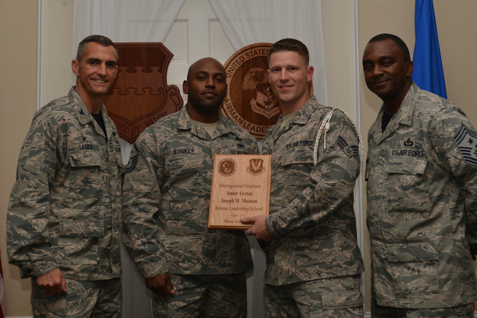 U.S. Air Force Senior Airman Joseph Munson, 3rd Intelligence Squadron, receives a distinguished graduate award for the Senior Master Sgt. David B. Reid Airman Leadership School Class 17-1 at Shaw Air Force Base, S.C., Nov. 18, 2016. The distinguished graduate awards are given to the top 10 percent of the class for total point accumulation. (U.S. Air Force photo by Airman 1st Class Christopher Maldonado)