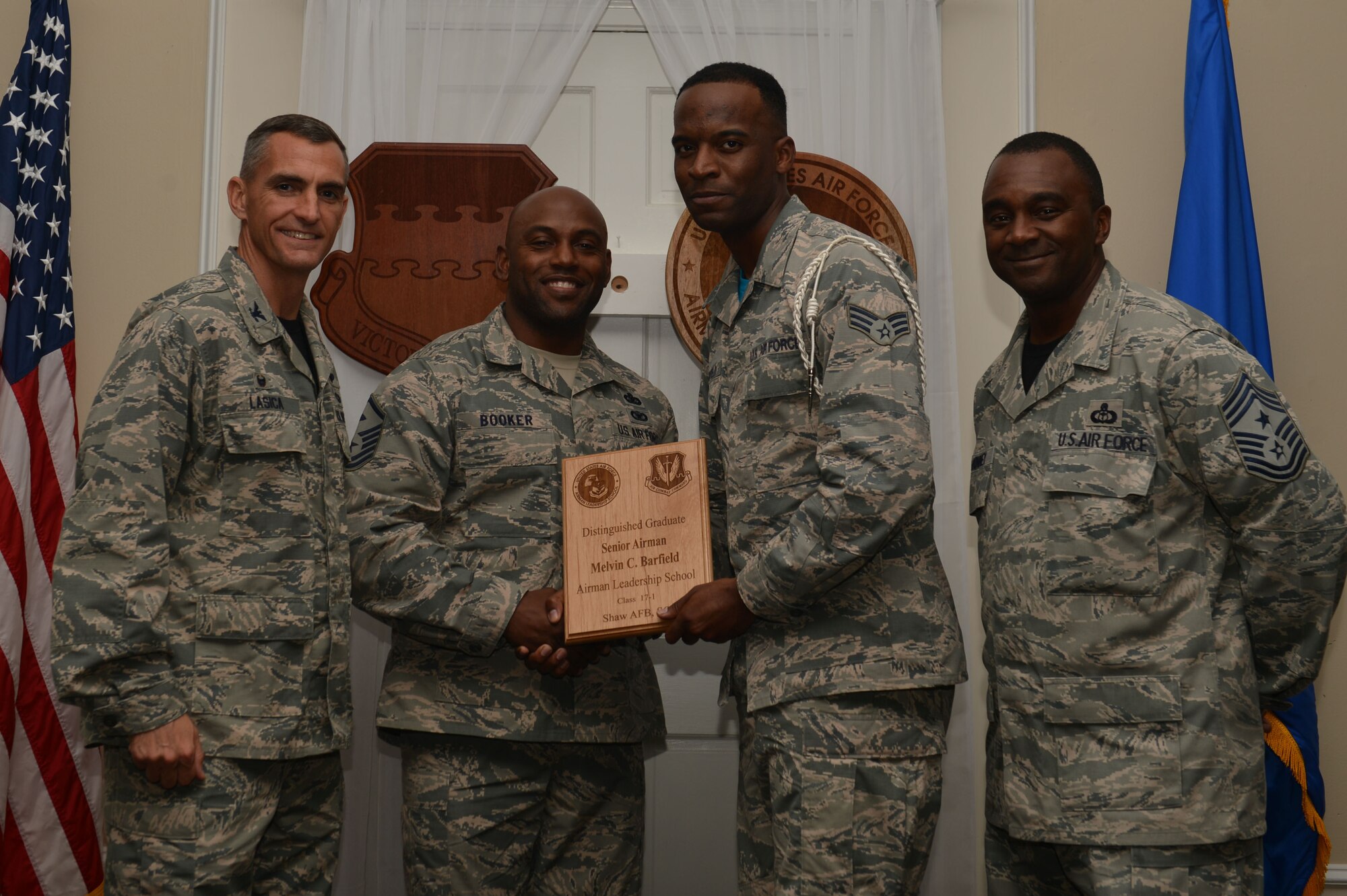 U.S. Air Force Senior Airman Melvin Barfield, 51st Intelligence Squadron, receives a distinguished graduate award for the Senior Master Sgt. David B. Reid Airman Leadership School Class 17-1 at Shaw Air Force Base, S.C., Nov. 18, 2016. The distinguished graduate awards are given to the top 10 percent of the class for total point accumulation. (U.S. Air Force photo by Airman 1st Class Christopher Maldonado)