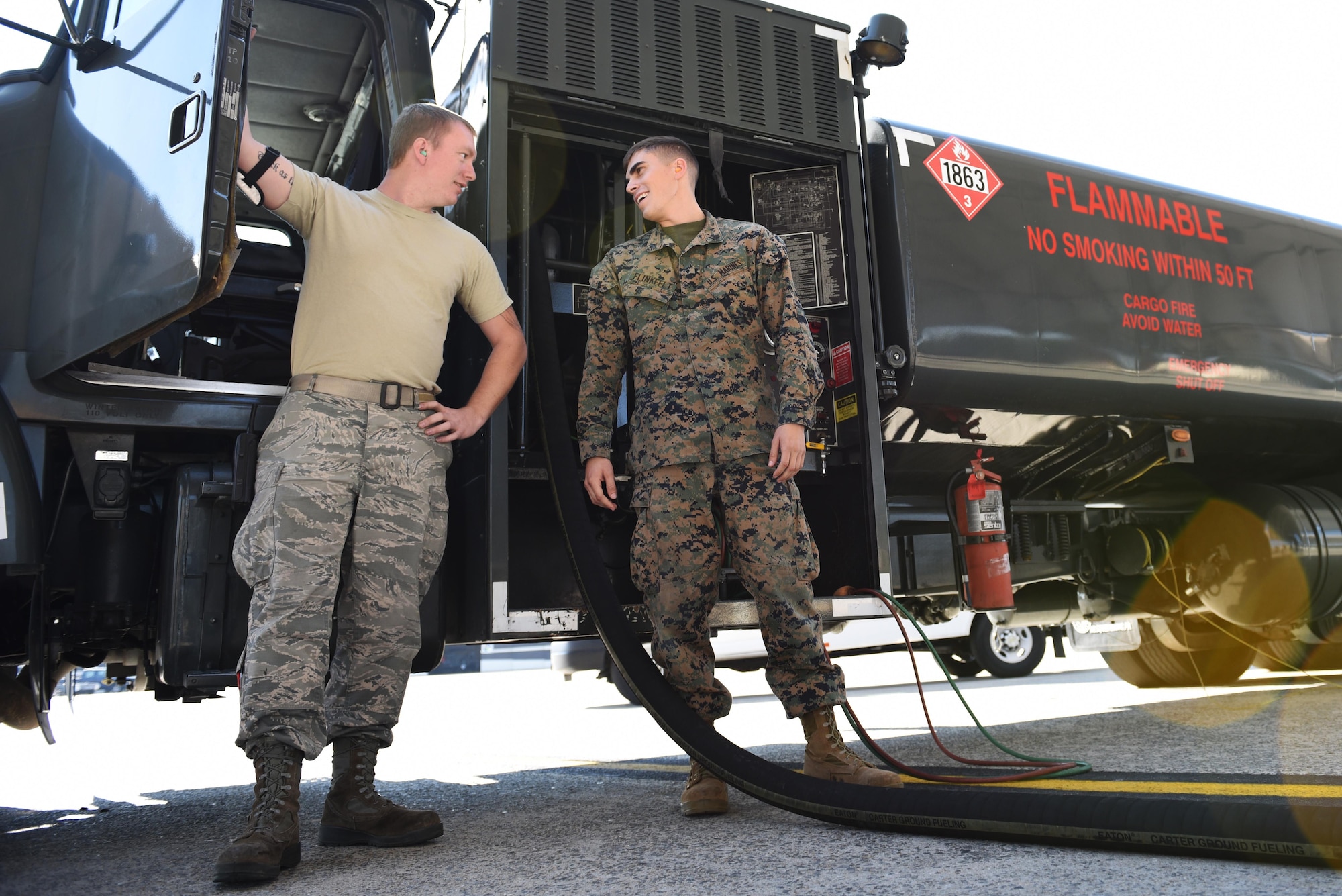 An Airman and a Marine prepare to refuel an F-15E Strike Eagle Nov. 16, 2016 Seymour Johnson Air Force Base, North Carolina. The Marines are training to use the R-11 aircraft refueler before they deploy to Morón Air Base, Spain. (U.S. Air Force photo by Airman 1st Class Kenneth Boyton)