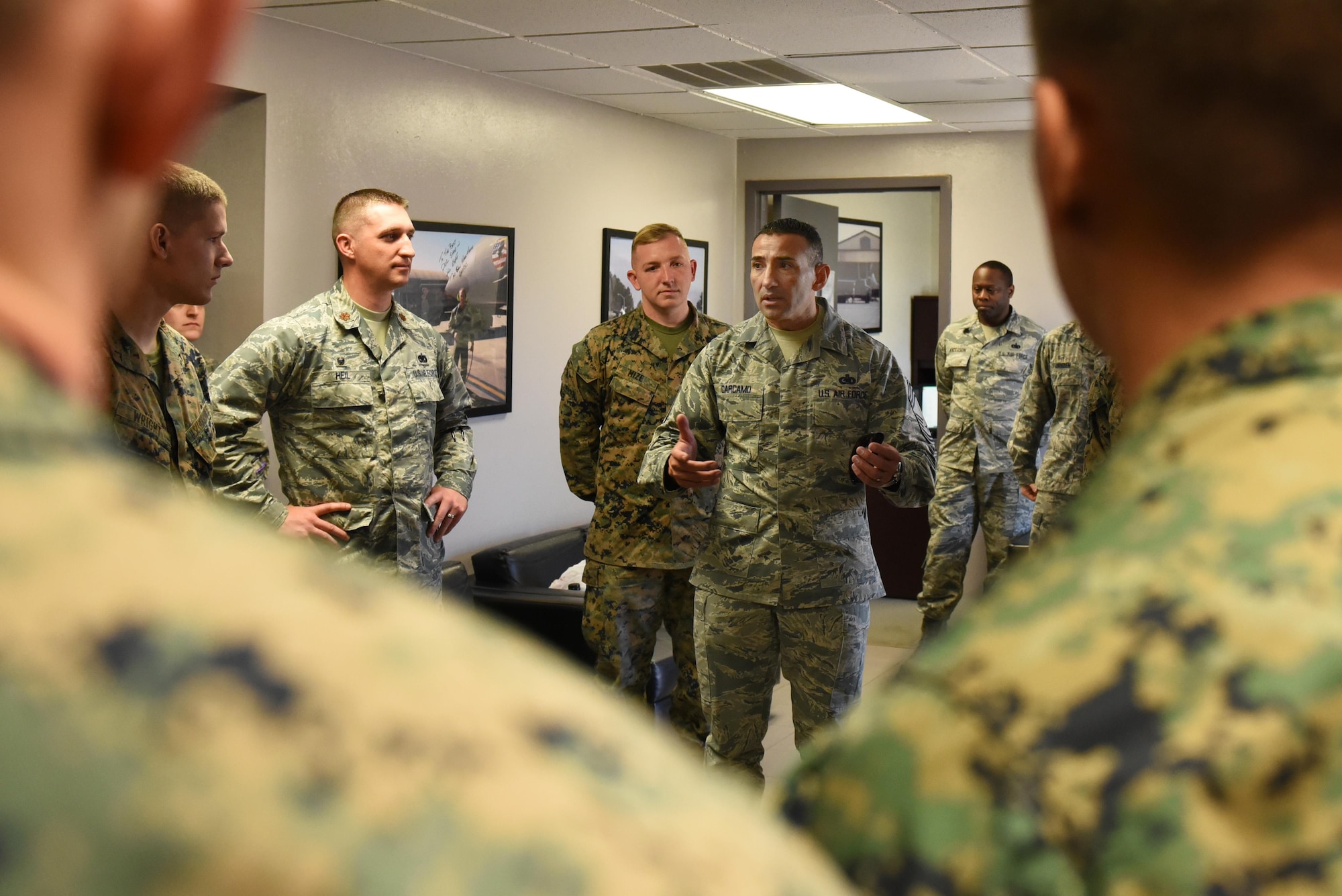Chief Master Sgt. Marlon Carcamo, 4th Logistics Readiness Squadron chief enlisted manager, talks to Marines and Airmen Nov. 17, 2016 Seymour Johnson Air Force Base, North Carolina. Airmen trained Marines in a week-long joint training exercise to familiarize the Marines with the R-11 aircraft refueler before their deployment to Morón Air Base, Spain. (U.S. Air Force photo by Airman 1st Class Kenneth Boyton)