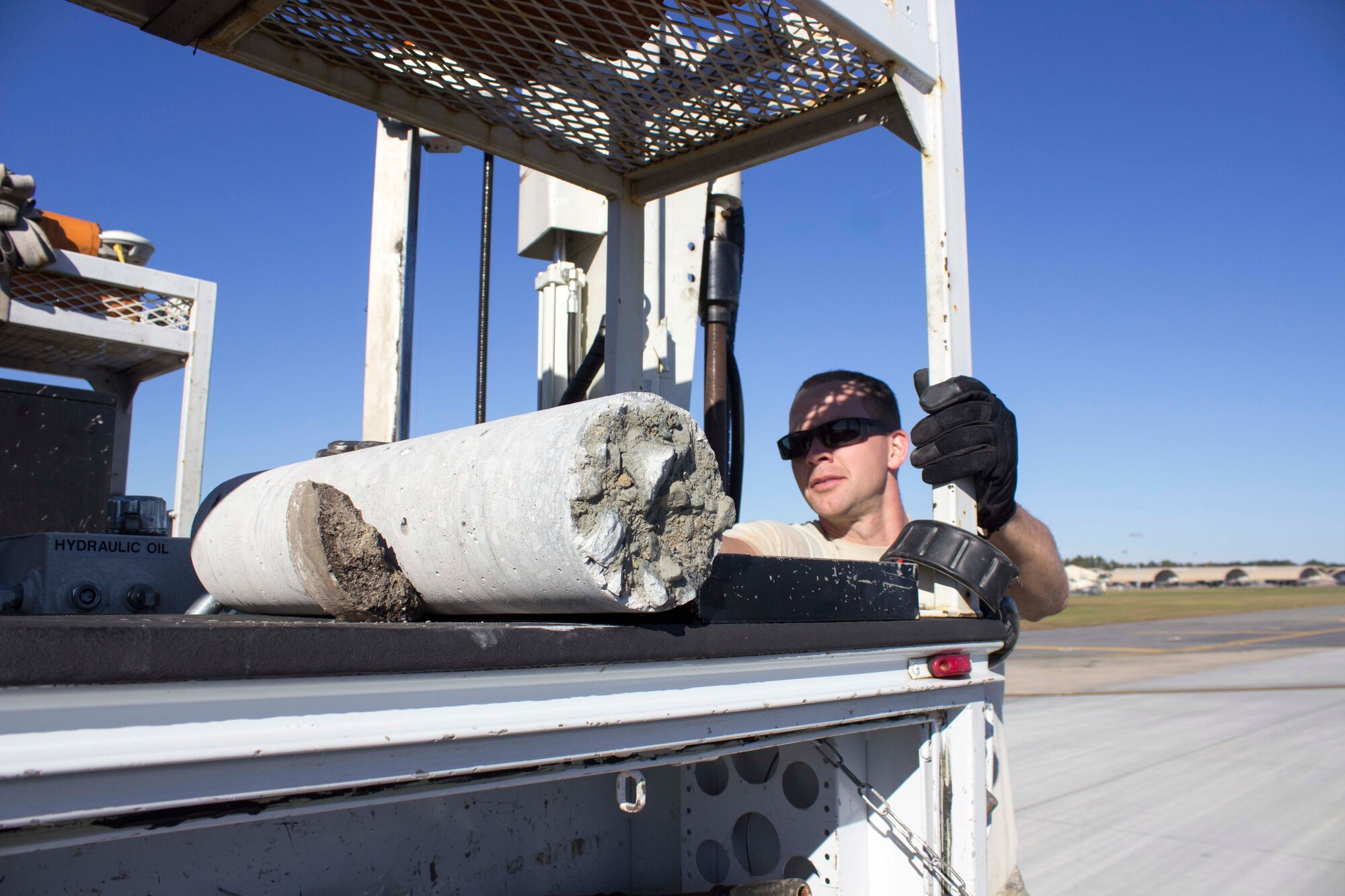 Staff Sgt. Eric Carpenter of the APE team stabilizes a core sample taken from Seymour Johnson Air Force Base, North Carolina, during a recent airfield pavement evaluation provided in response to flooding from Hurricane Matthew. The team traveled to the base to assess the runway for structural integrity concerns from the flooding. (U.S. Air Force Photo/Susan Lawson)

