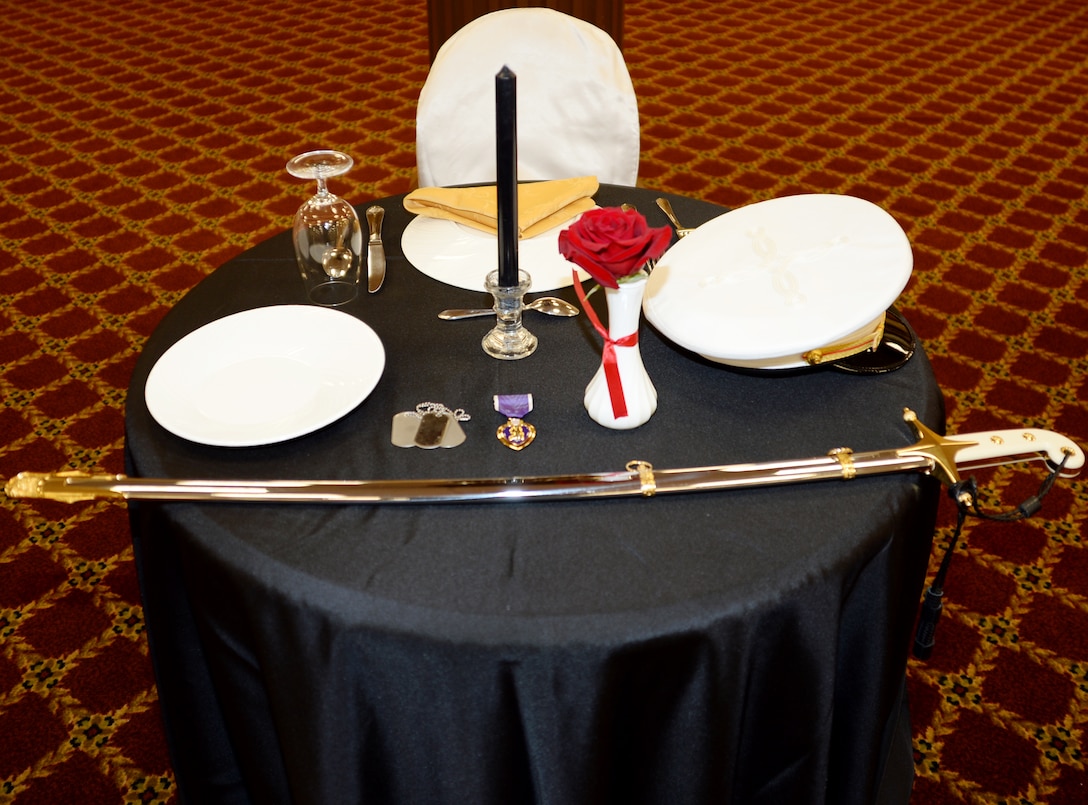 The Fallen Comrade Table stands as a reminder of those who are still missing in action and those who made the ultimate sacrifice for freedom. The table is set for one, however there are many represented by the single chair.