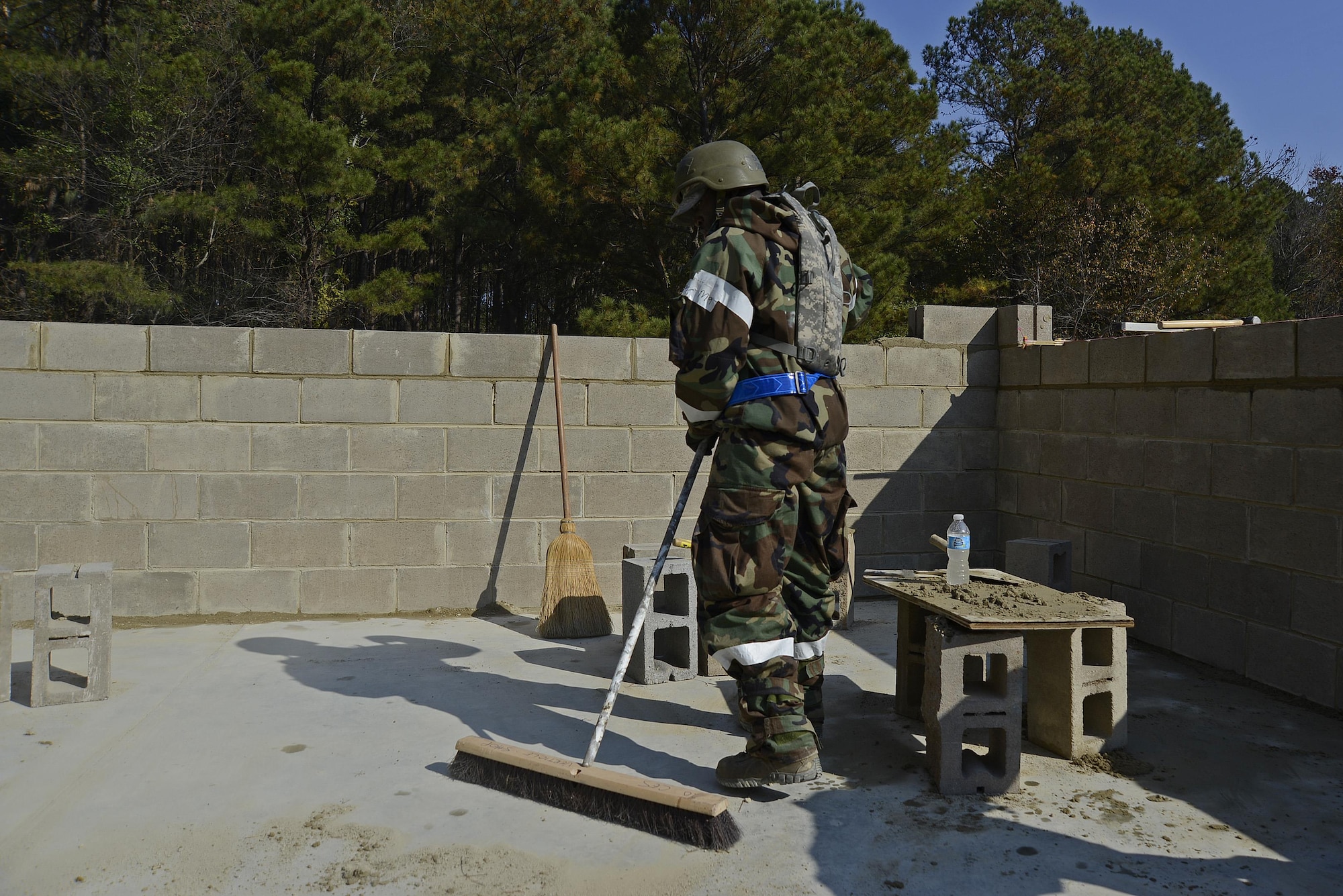U.S. Air Force Senior Airman Rashon Reid, 20th Civil Engineer Squadron structural journeyman, sweeps away leftover mortar at Shaw Air Force Base, S.C., Nov. 16, 2016. Mortar is the substance that keeps a brick structure together. (U.S. Air Force photo by Airman 1st Class BrieAnna Stillman)