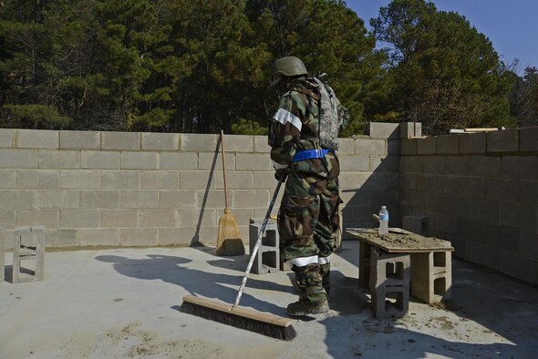 U.S. Air Force Senior Airman Rashon Reid, 20th Civil Engineer Squadron structural journeyman, sweeps away leftover mortar at Shaw Air Force Base, S.C., Nov. 16, 2016. Mortar is the substance that keeps a brick structure together. (U.S. Air Force photo by Airman 1st Class BrieAnna Stillman)