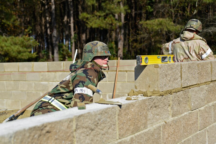 U.S. Air Force Airman 1st Class Nathen Trevino, 20th Civil Engineer Squadron structural apprentice, ensures a brick is level at Shaw Air Force Base, S.C., Nov. 16, 2016. Airmen from the 20th CES built an alternate Unit Control Center facility during operational readiness exercise Weasel Victory 17-03. (U.S. Air Force photo by Airman 1st Class BrieAnna Stillman)