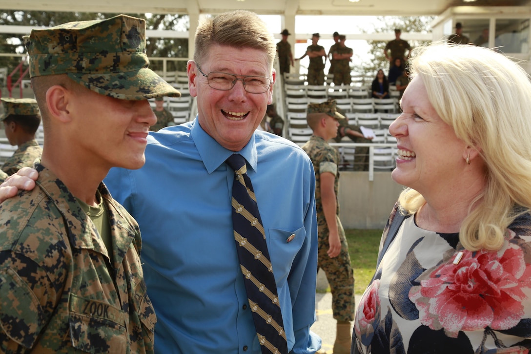 Private Joshua D. Zook reunites with his parents, Mark and Karen Zook, Oct. 14, 2016, after 13 weeks of recruit training aboard Marine Corps Recruit Depot, Parris Island, South Carolina. Mark and Karen are a Gold Star family. According to the National Gold Star Family Registry, the Department of Defense (DoD) distributes a Gold Star Lapel Button, also referred to as the Gold Star lapel, to members of the immediate family of a fallen service member. (Courtesy Photo)

