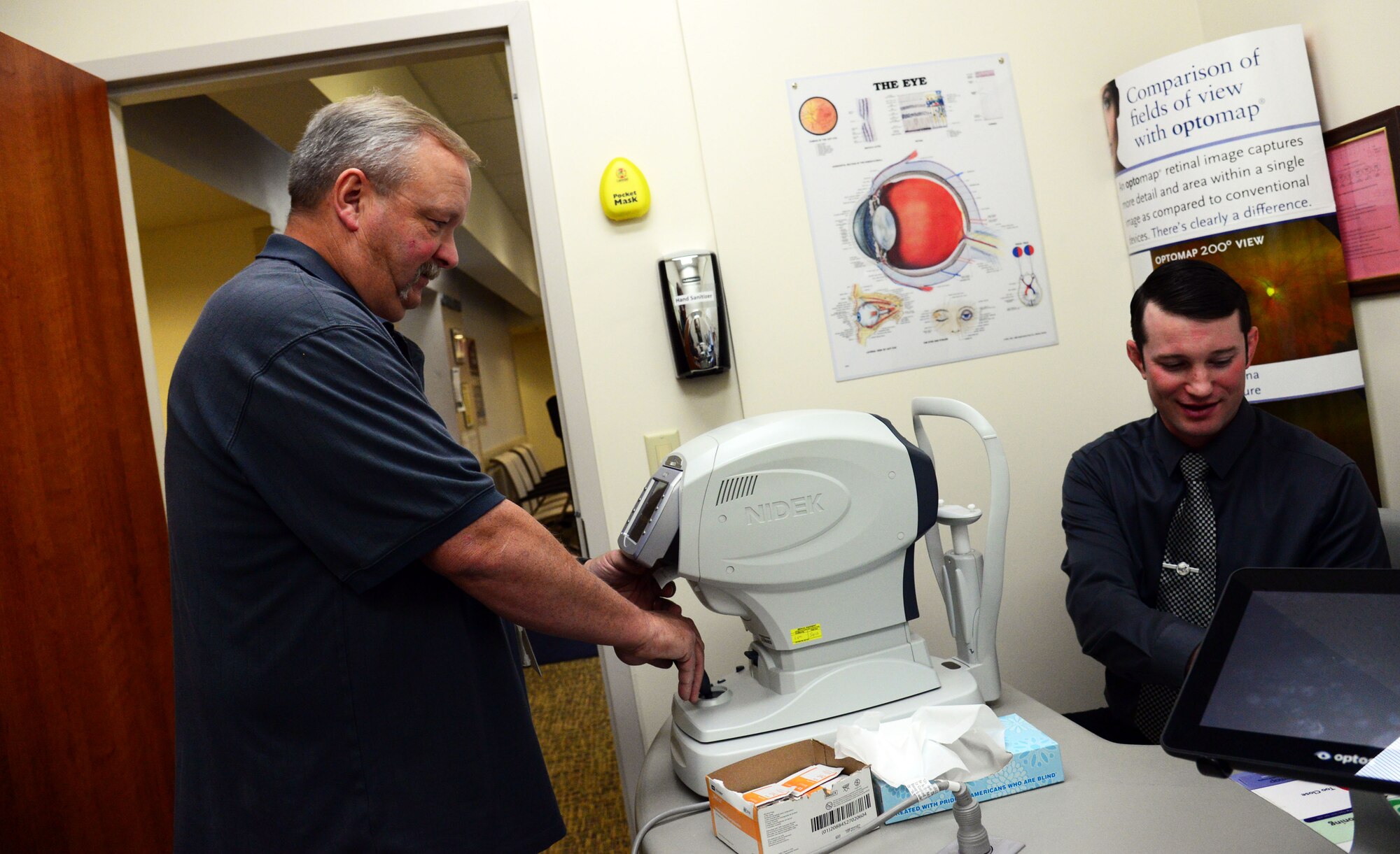 John Dresel, 341st Medical Operations Squadron optometry technician, demonstrates preliminary testing with Tel Todd, former optometry clinic intern, Nov. 2, 2016, at Malmstrom Air Force Base, Mont. Dresel says his primary function in the optometry clinic is to provide excellent customer service and to administer preliminary testing to patients before they are seen by the doctor. (U.S. Air Force photo/Airman 1st Class Magen M. Reeves)