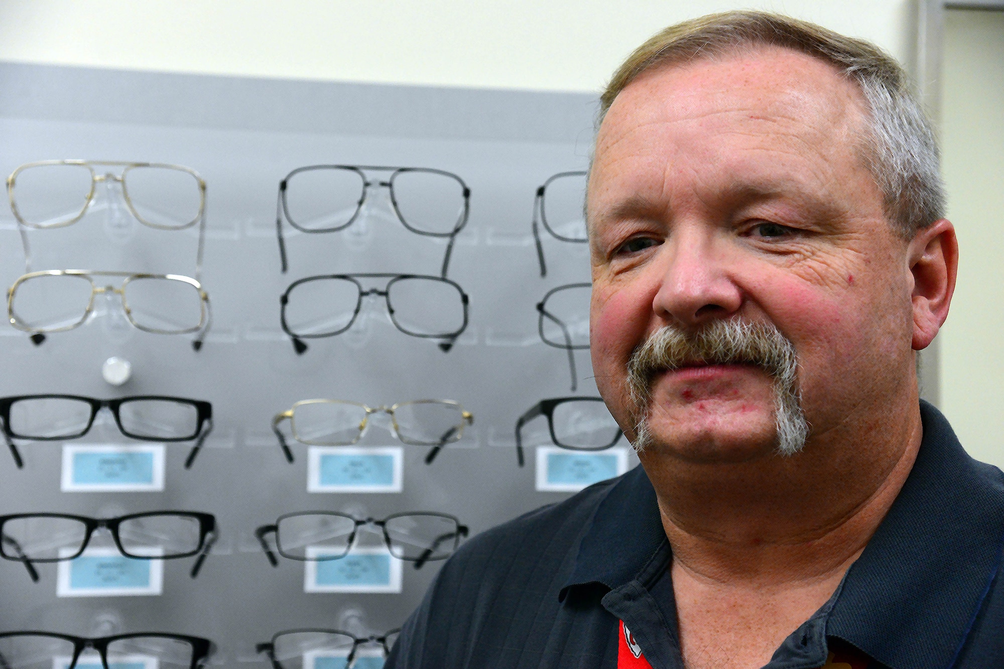 John Dresel, 341st Medical Operations Squadron optometry technician, poses for a photo in the optometry clinic Nov. 2, 2016, at Malmstrom Air Force Base, Mont. Dresel recently received the Civilian Category 1 award for the third quarter partly due to his outstanding customer service. (U.S. Air Force photo/Airman 1st Class Magen M. Reeves)