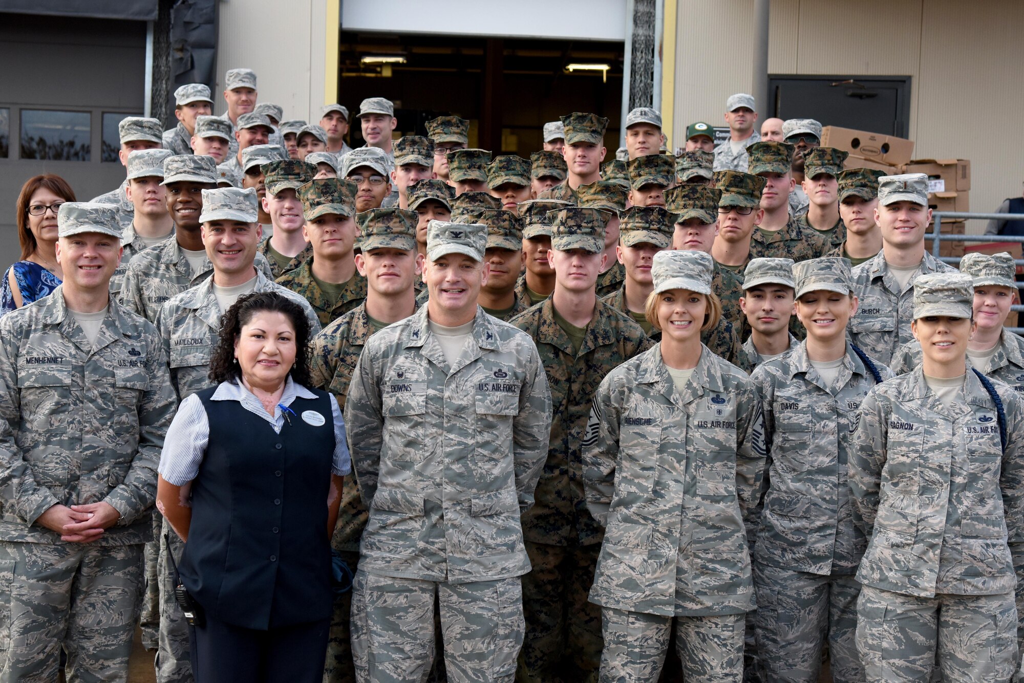 Operation Warmheart volunteers pose for a group photo at the commissary on Goodfellow Air Force Base, Texas, Nov. 22, 2016. Service members came together to help build baskets to ease the cost of Thanksgiving dinner for Goodfellow members in need.  (U.S. Air Force photo by Senior Airman Joshua Edwards/Released)