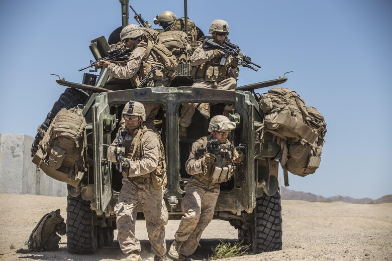 Marines dismount from a Light Armored Reconnaissance Vehicle to raid a compound during the 11th Marine Expeditionary Unit’s Combined Arms Exercise at Marine Corps Air Ground Combat Center Twentynine Palms, Calif., June 12, 2016. Well-planned and aggressive training like this prepares the individual Marine to fulfill their role on the team, which in turn builds unit cohesion and increases the speed of mission accomplishment. MEUCAX is conducted to maintain a high level of combat readiness prior to the MEU’s Western Pacific 16-2 deployment later this year. The Marines are with LAR Company, Battalion Landing Team 1st Bn., 4th Marines, 11th MEU. (U.S. Marine Corps photo by Lance Cpl. Zachery Laning/Released)